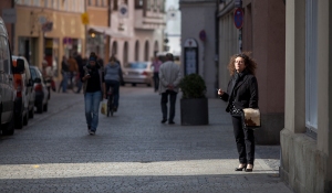 A WOMAN TAKES A SMOKE BREAK IN PASSAU, GERMANY